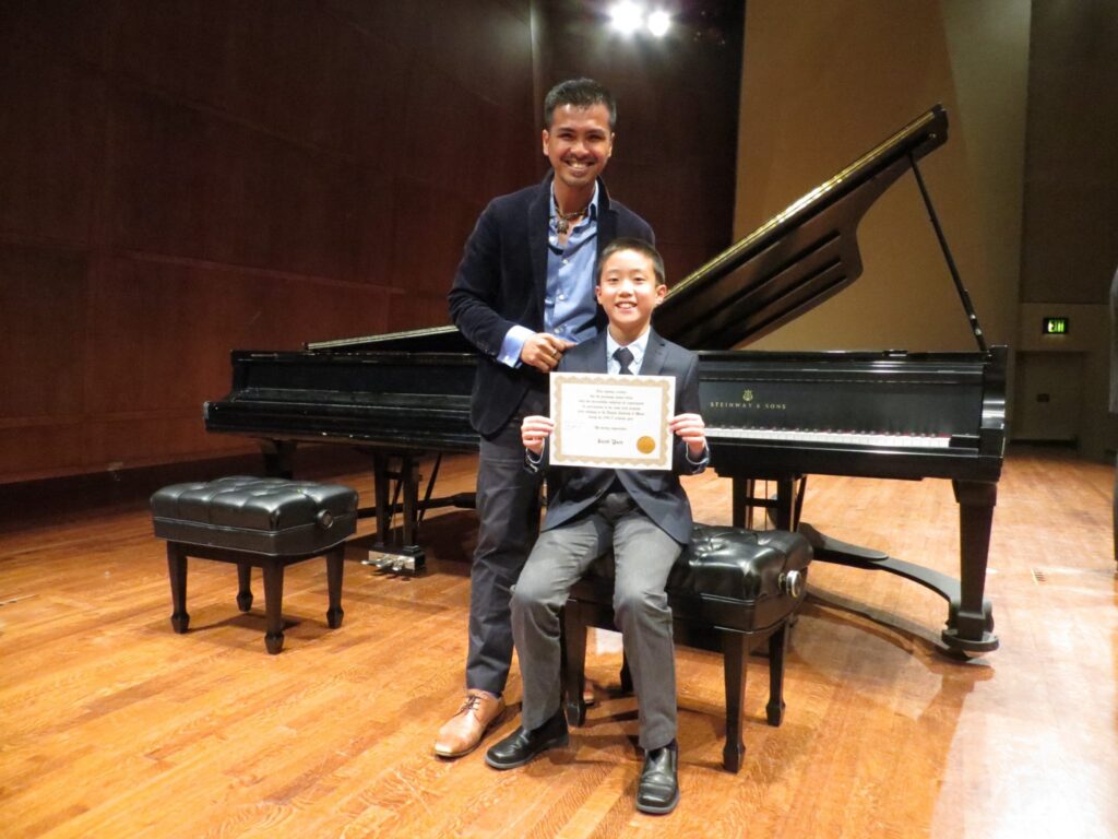 CAM Faculty Member with student after successfully completing the year's requirements