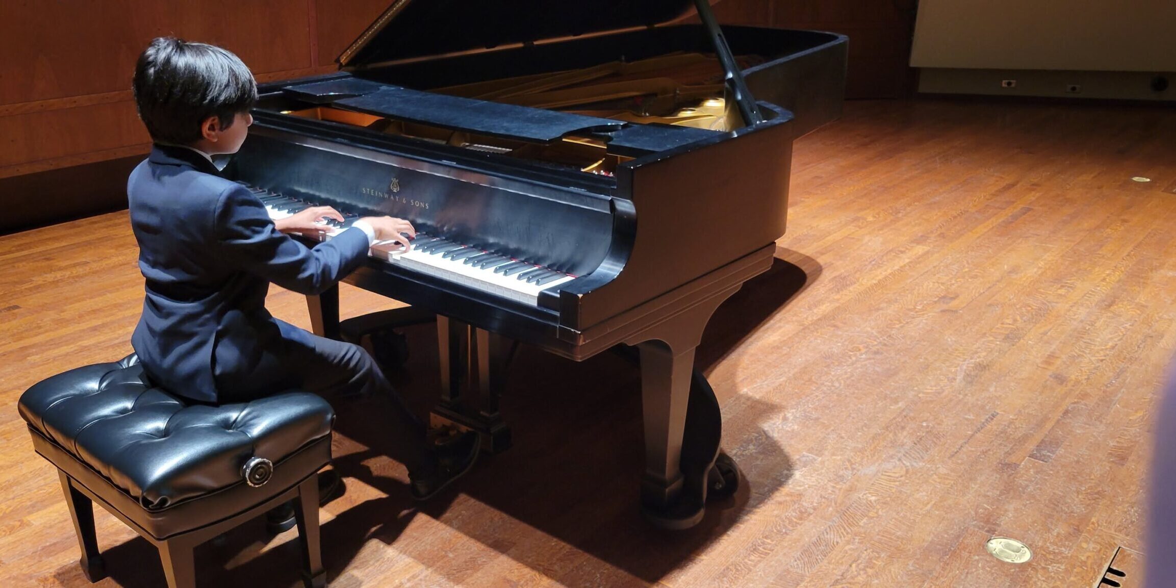 Chopin Academy of Music student on stage before the Honors Recital