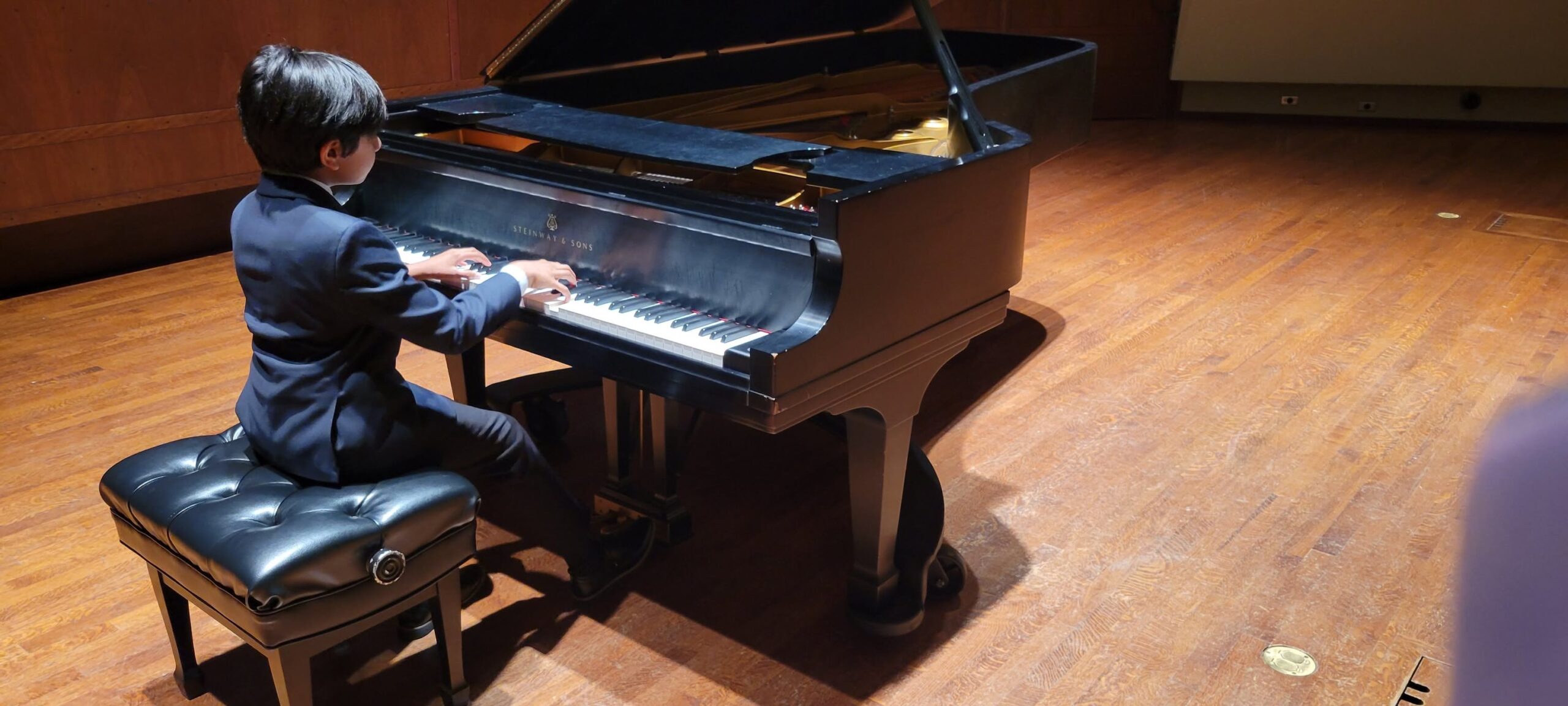 Chopin Academy of Music student on stage before the Honors Recital